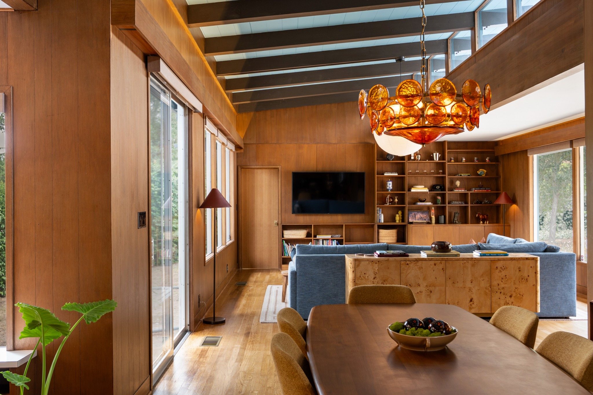 Open Mid-Century Modern living and dining area with walls of glass